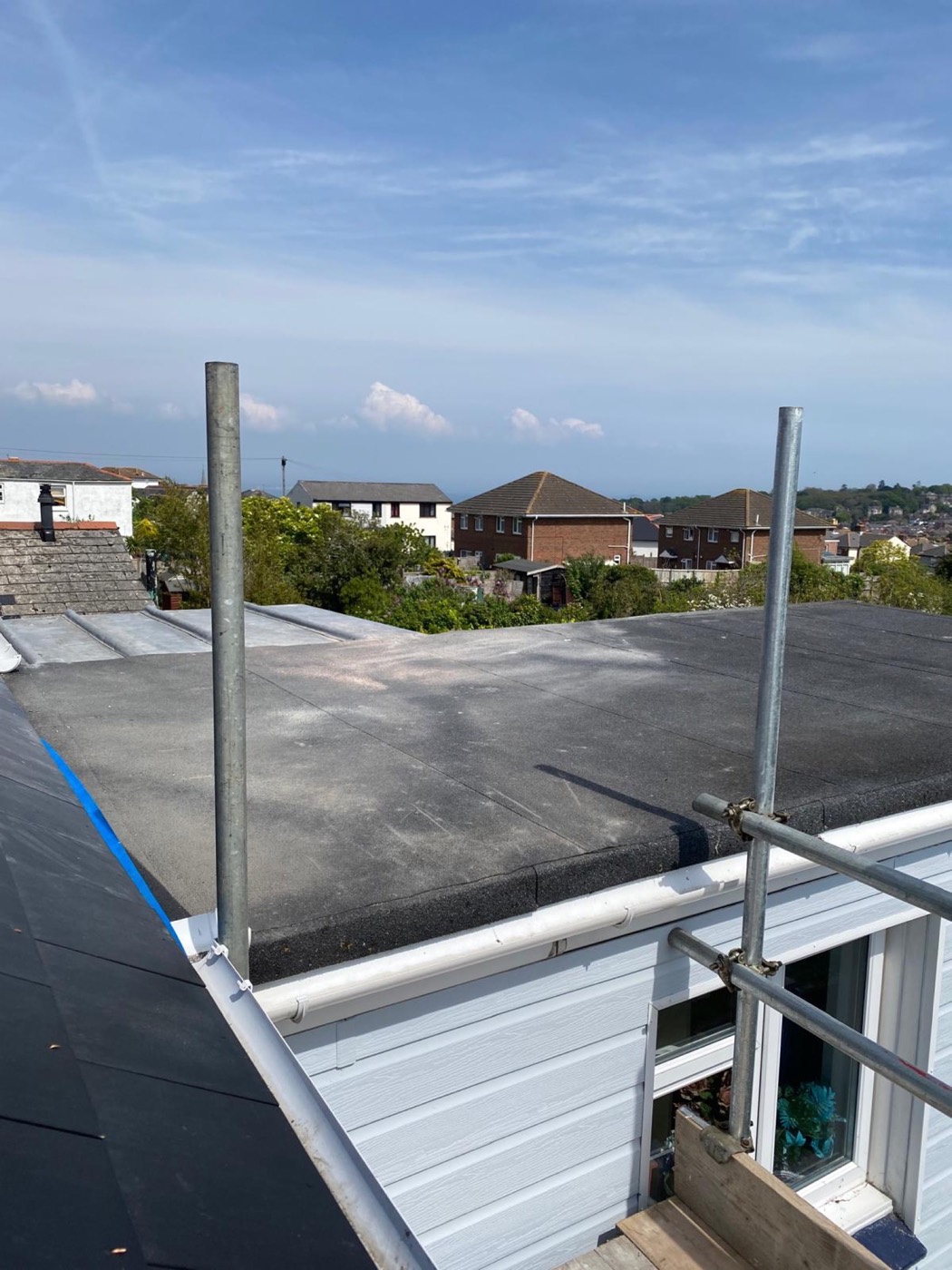 Finished torch-on felt flat roof with upstand edges and new fascia and gutter below