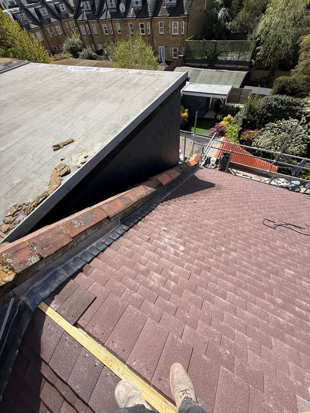 Lead-lined gutter and abutment dressed in against an older asphalt flat roof