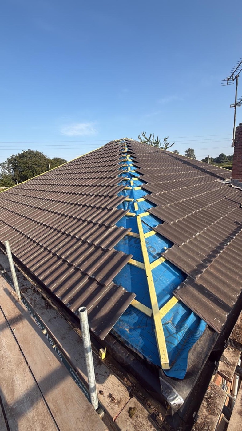 New pantile roof on a hipped bungalow with the ridge open over breather membrane