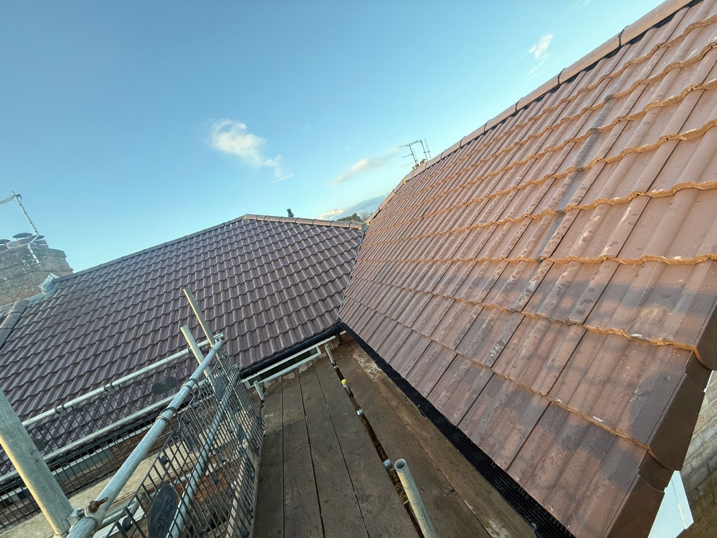 Two freshly tiled pantile slopes meeting in a new valley