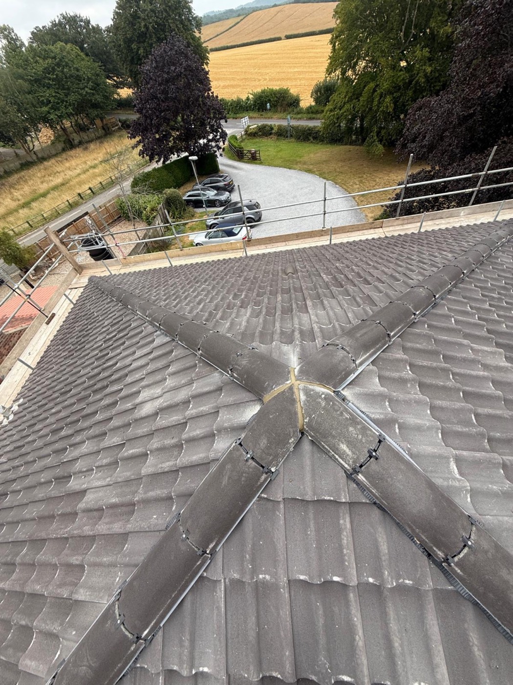 Finished pantile hipped roof looking down the apex where the hips meet the ridge