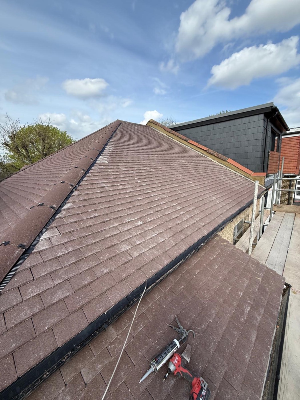 Finished plain-tile hipped roof with crisp new hip and ridge lines