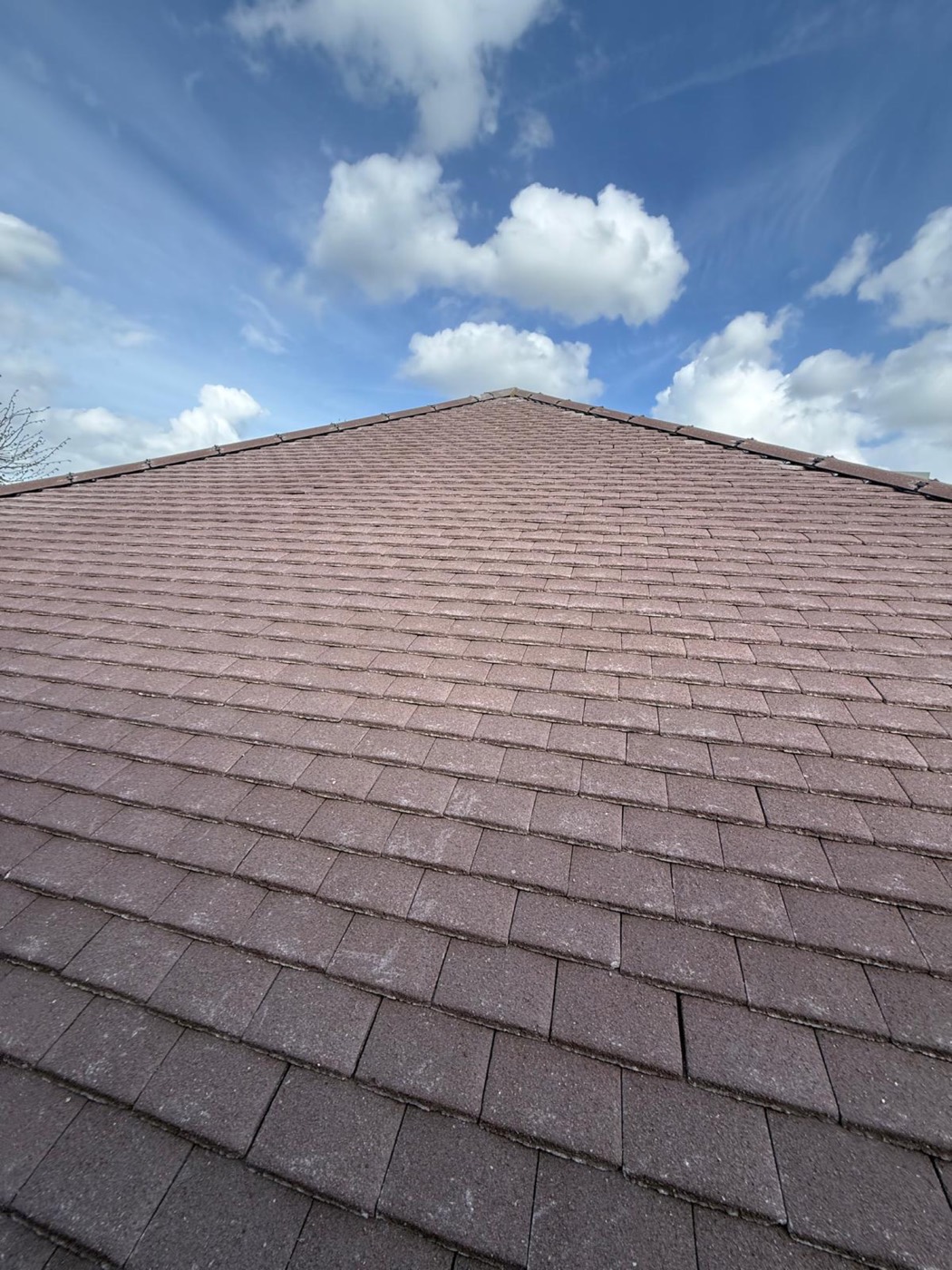 A finished plain-tile slope rising to a newly bedded ridge